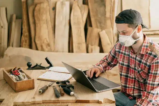 wood working man with his laptop